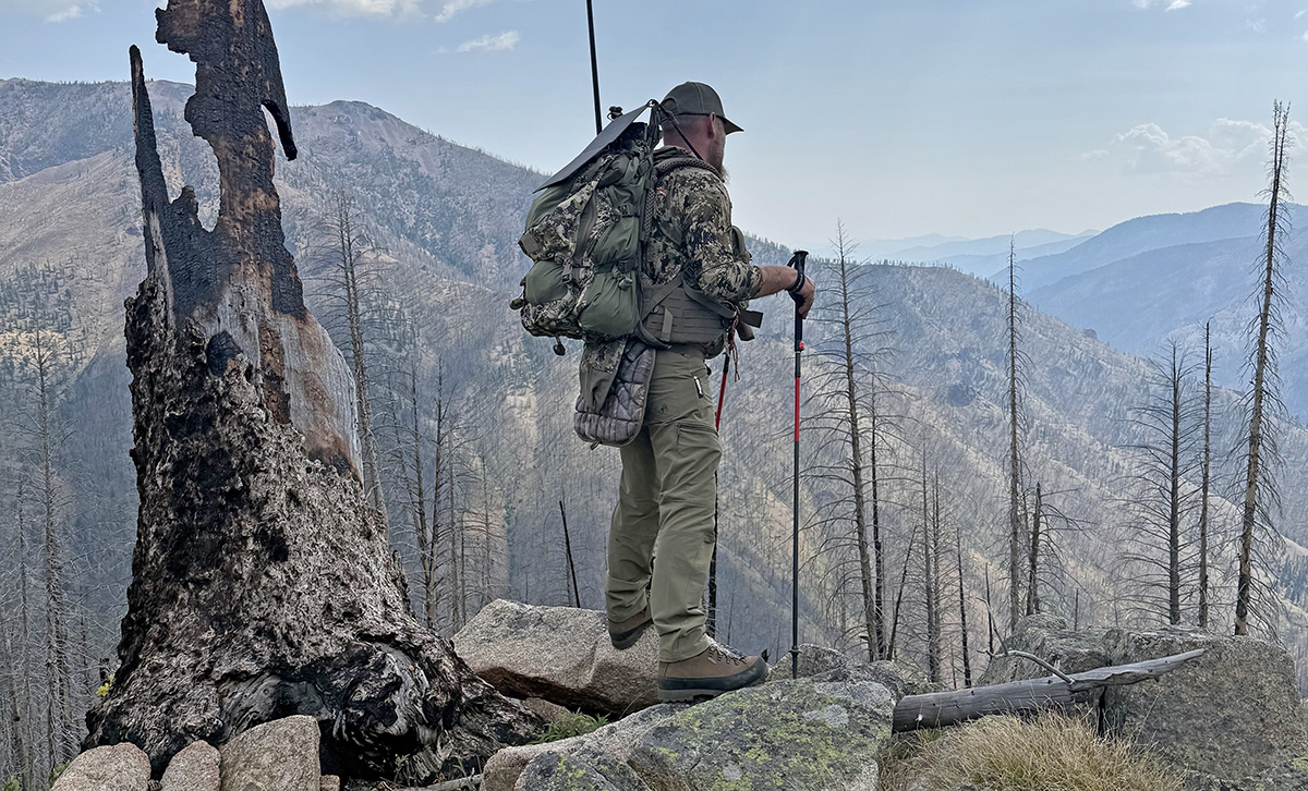 Hunter on the top of a jagged mountain